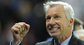 Pardew smiling and pumping his little fist with glee.